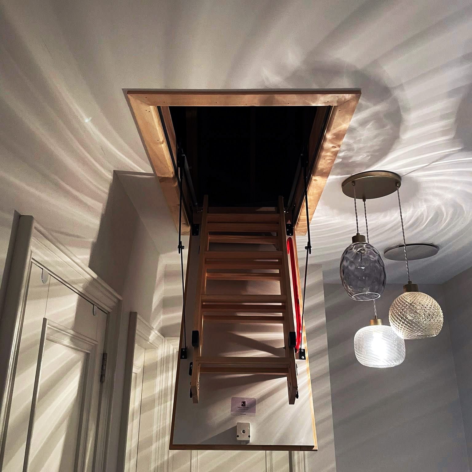 Loft ladder entrance beside fancy lights